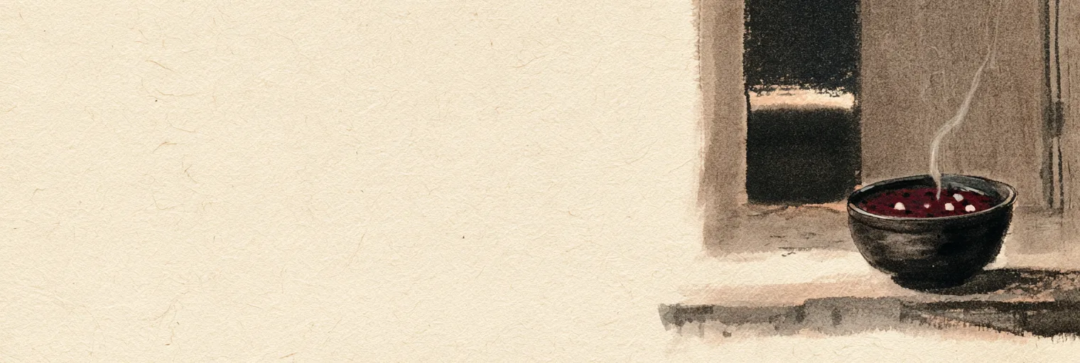Korean ink-wash painting on aged hanji paper of a single dark bowl of deep red bean porridge with a few small white rice balls floating in it and a thin thread of steam rising, set on a flat stone doorstep in front of a plain wooden gate standing slightly open, with a narrow band of pale first light low on the horizon seen through the gap under a dark night sky, the bowl and gate placed in the right third of the paper and the left two thirds left empty, no people, no moon